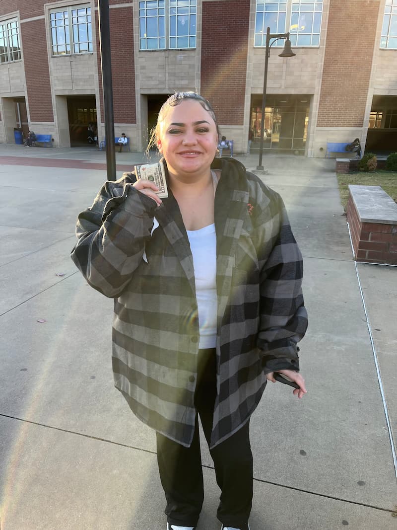 Student recipient smiling after receiving scholarship help