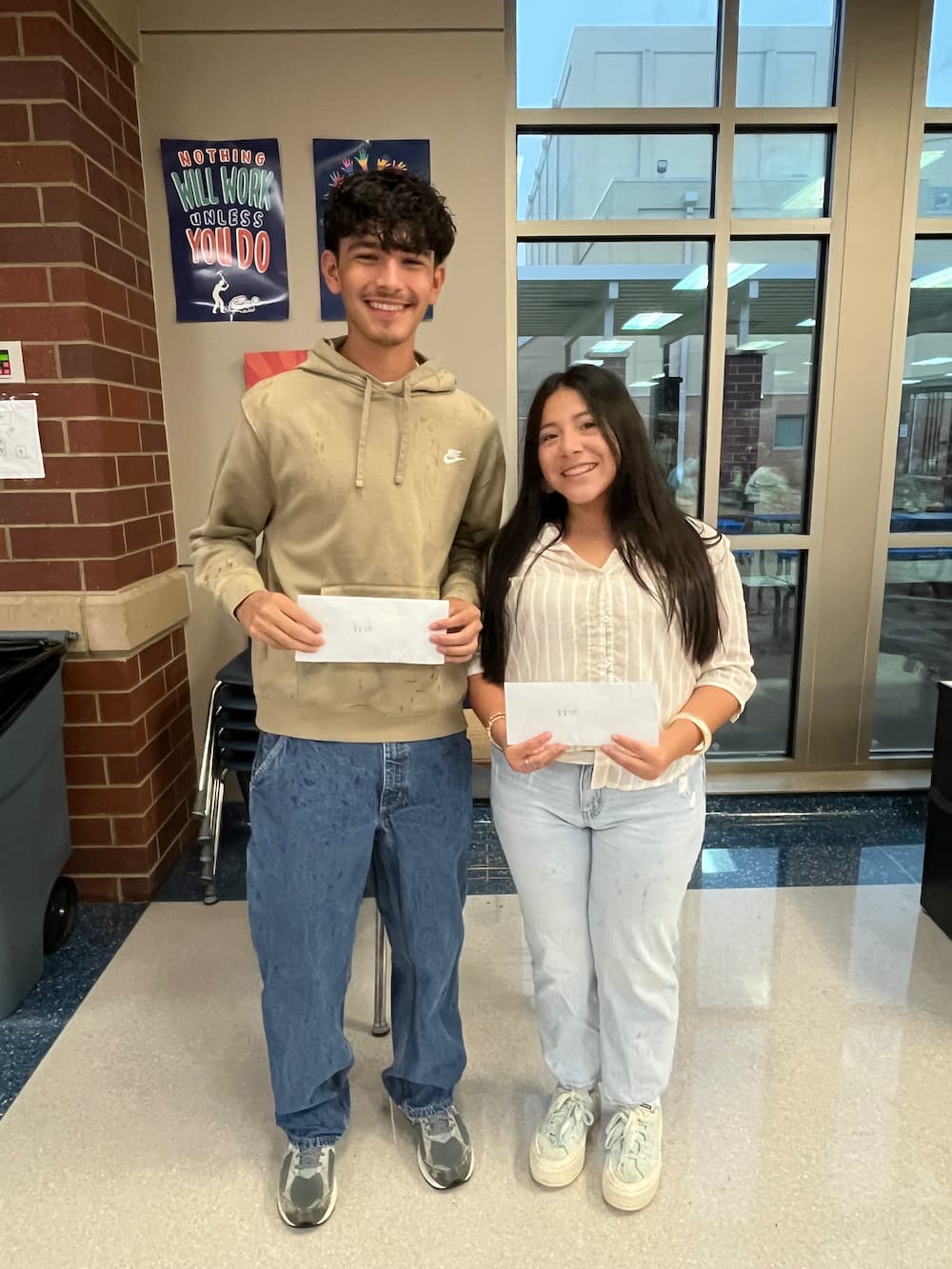 Two students celebrating with grant funds in hand